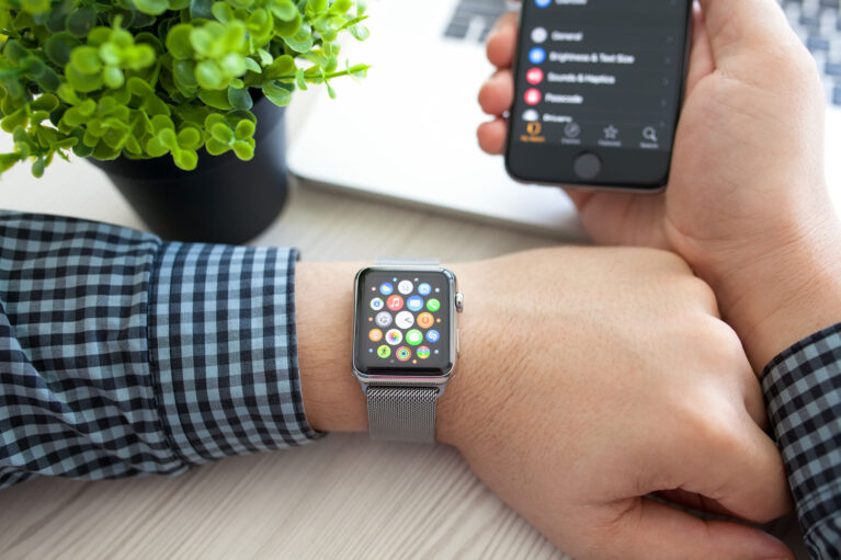 Man hand with Apple watch and app icon on the screen
